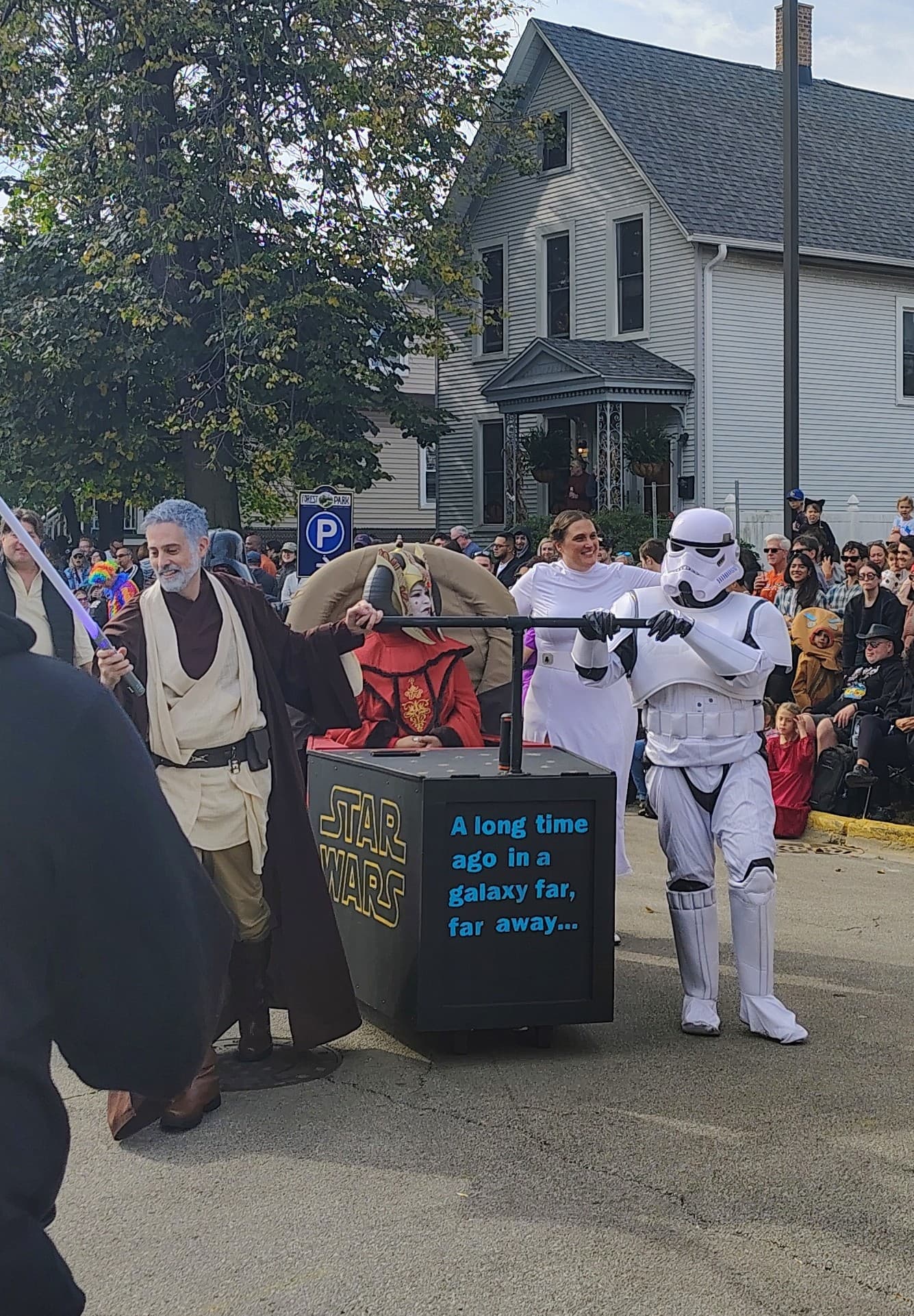 A Star Wars-themed casket with Obi-Wan, a Stormtrooper, and Princess Leia pushing it down Beloit Avenue, the words STAR WARS painted on the side